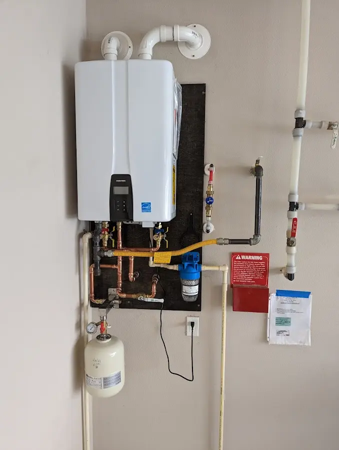 Professional plumber installing copper piping in a Colonial Heights home